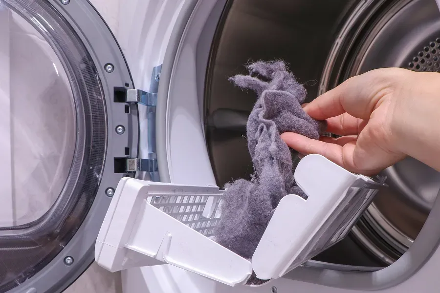 person-cleaning-dryer-lint-screen